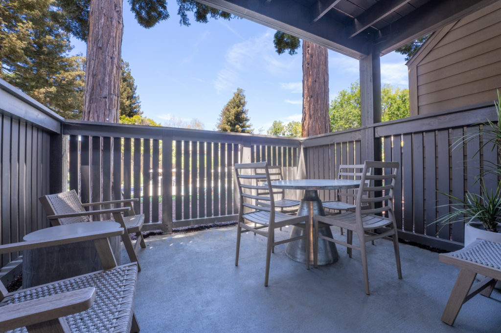 Outside patio metal round table with four chairs, two lounge chairs and coffee table