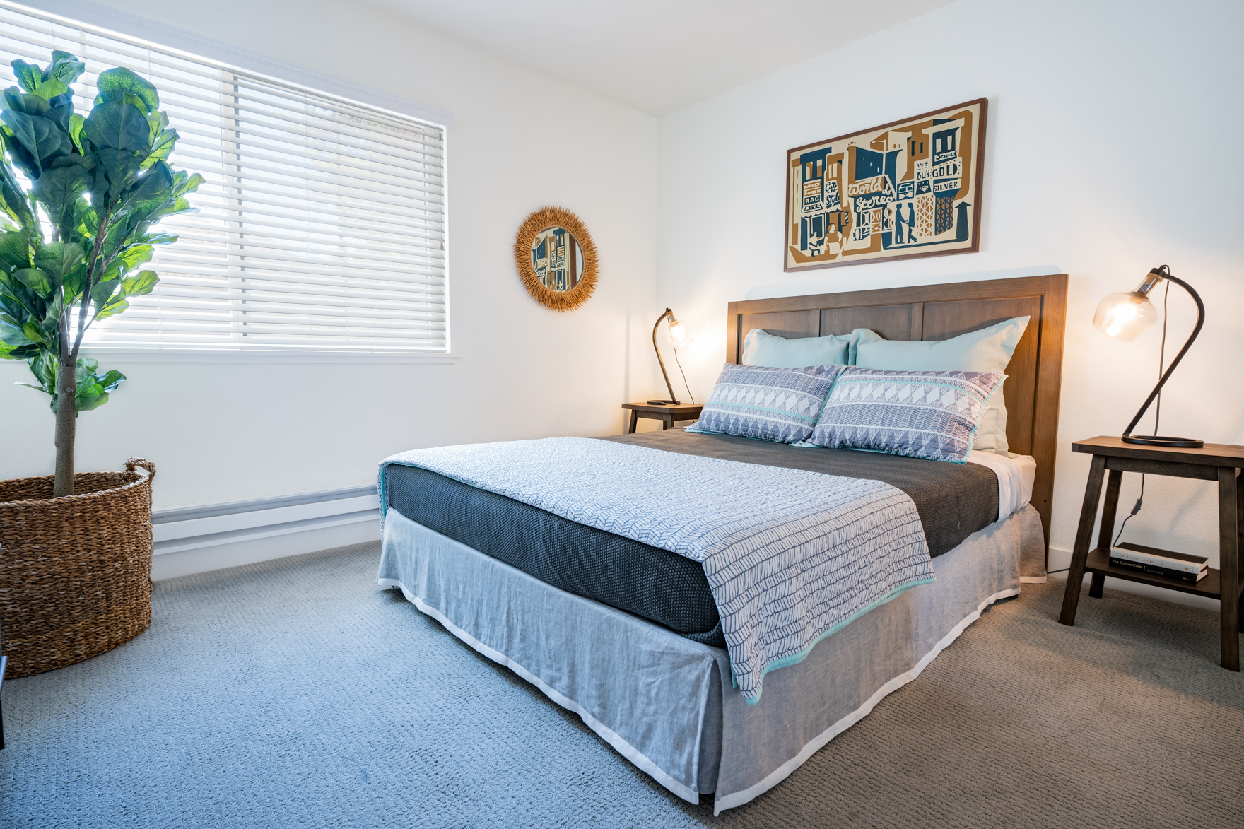 Kingsize bed grey carpet and large window in spacious bedroom