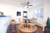 Dinning table and four wooden chairs under a ceiling fan in dinning room.